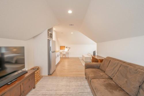 a living room with a couch and a kitchen at Scarlet Ridge Retreat - Near Wineries & DT Austin in Austin