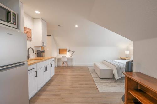 a kitchen with white cabinets and a bed in a room at Scarlet Ridge Retreat - Near Wineries & DT Austin in Austin