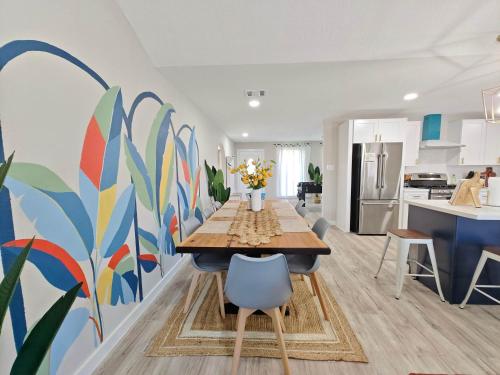 a dining room with a table and a colorful wall at Sageview Cottage - 4 BDR with Pool Pet Friendly in Houston