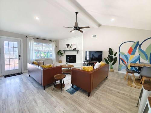 a living room with two couches and a tv at Sageview Cottage - 4 BDR with Pool Pet Friendly in Houston