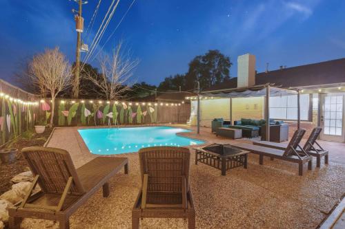 a backyard with a pool with chairs and a couch at Sageview Cottage - 4 BDR with Pool Pet Friendly in Houston