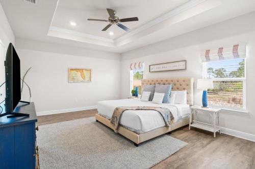 a bedroom with a bed and a ceiling fan at Beach House - Redfish Cove at Windmark Beach by Panhandle Getaways in Port Saint Joe