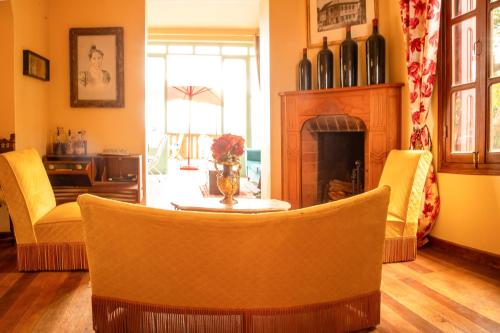 a living room with a table and a fireplace at Lokanga Boutique Hotel in Antananarivo