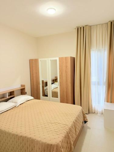 a bedroom with a bed and a large window at Brand New Apartment- Flower Nest by Verdant Garden C1-4 in Moka