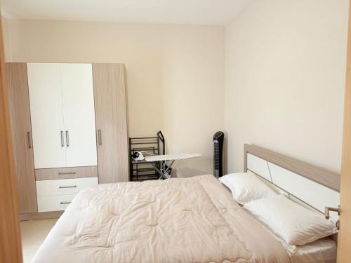 a bedroom with a white bed and a mirror at Brand New Apartment- Flower Nest by Verdant Garden C1-4 in Moka