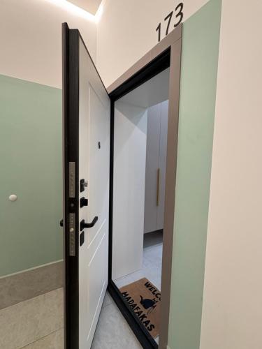 a door with a mirror in a room at двухкомнатная студия с красивой набережной in Astana