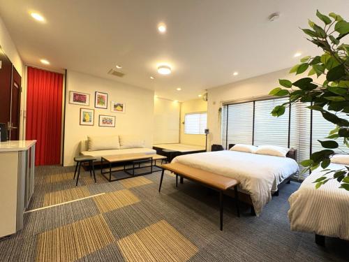 a hotel room with two beds and a couch at Frontier First Building - Vacation STAY 19759 in Kagoshima