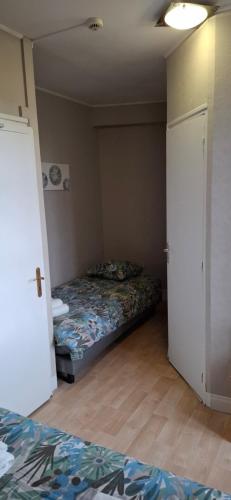a bedroom with two beds and a door open at Hotel Le Marrakech in Châteauneuf-dʼIlle-et-Vilaine
