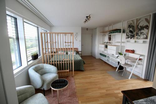 a living room with a bed and a desk at Studio Horizon Dorigny in Lausanne