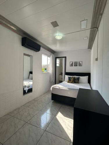 a bedroom with a bed and a desk in it at Canto da Praia Balneário Camboriú in Balneário Camboriú