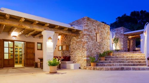 a stone house with stairs leading to the entrance at Villa Sa Paissa in Cala Vadella