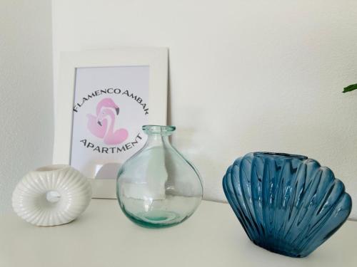 a shelf with a blue glass vase and a plate at Flamenco Ambar Luxury Apartment 15 Planta in Calpe
