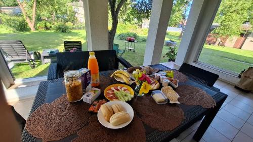 un tavolo con piatti di cibo e bevande sopra di Cozy Garden Villa a Ventspils