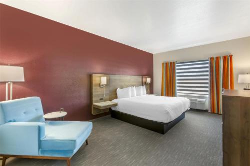 a hotel room with a bed and a chair at Best Western Plus Casa Grande Inn & Suites in Casa Grande