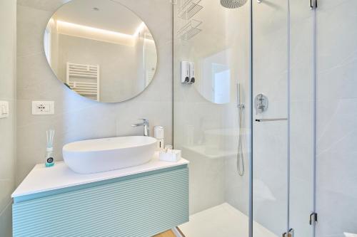 a bathroom with a sink and a mirror at Bari Giannini1 Luxe Apartment in Bari