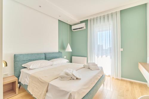 a bedroom with a bed with towels on it at Bari Giannini1 Luxe Apartment in Bari