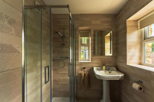 a bathroom with a glass shower and a sink at Moneen Mountain View in Kinlough