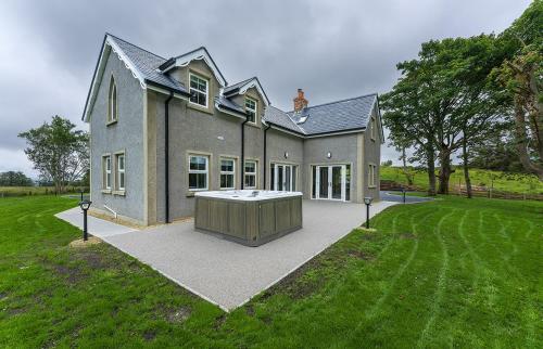 a large house with a hot tub in the yard at Moneen Mountain View in Kinlough