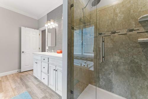 a bathroom with a shower and a sink at Leeloo's on the Lake - Sleeps 12 in Lexington