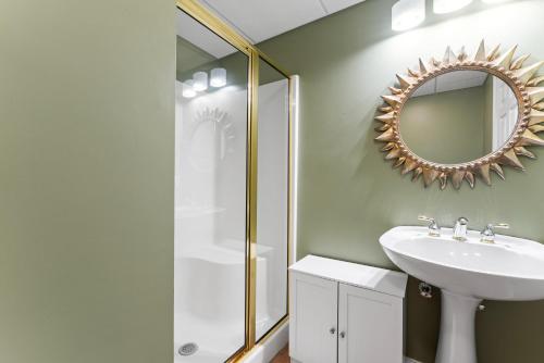a bathroom with a sink and a mirror at Leeloo's on the Lake - Sleeps 12 in Lexington