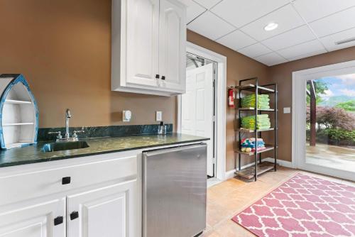 a kitchen with a sink and a dishwasher at Leeloo's on the Lake - Sleeps 12 in Lexington