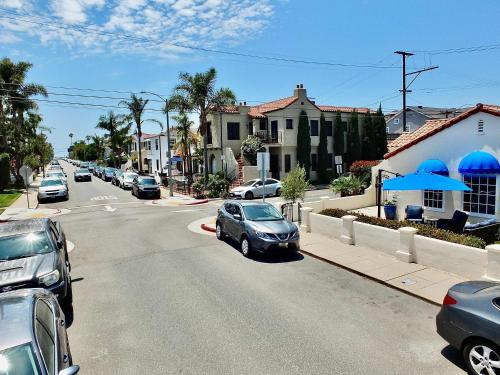 a street with cars parked on the side of the road at Belmont Shore Beach House - Incredible Oceanfront Views in Long Beach