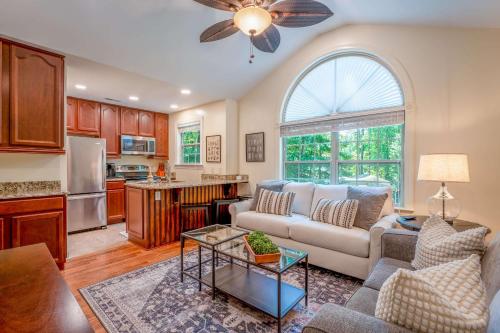 a living room with a couch and a kitchen at Dragonfly Cove - Private Dock in Mooresville
