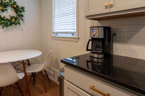 a kitchen with a counter top with a coffee maker at 4 BR Sleeps 10 Near UGA & Downtown in Athens