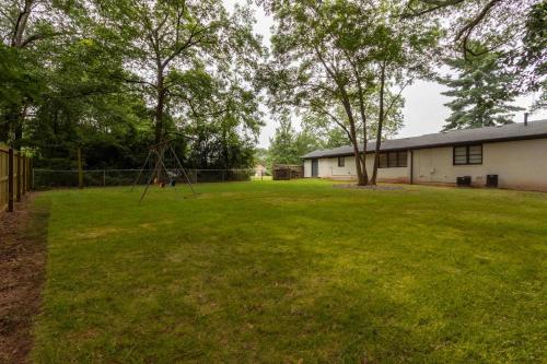 a large yard with a swing set in the grass at 4 BR Sleeps 10 Near UGA & Downtown in Athens