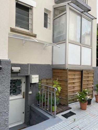 a house with a door and a balcony with plants at Studio côté Parc des Contades in Strasbourg