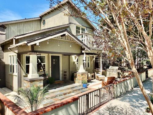 a house with a porch and a fence at Park Avenue Beach Paradise - Chic & Secluded 4 BDR in Long Beach