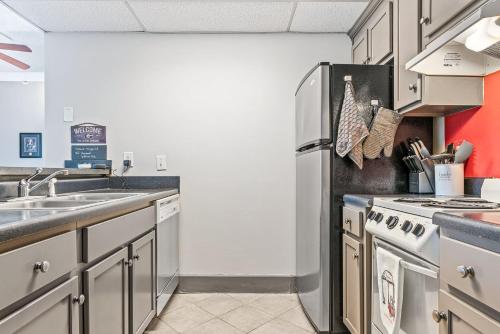 a kitchen with a refrigerator and a sink at Home is Where the Arch is - Across from UGA in Athens