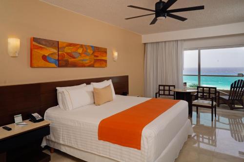 a bedroom with a bed and a view of the ocean at Flamingo Cancun All Inclusive in Cancún