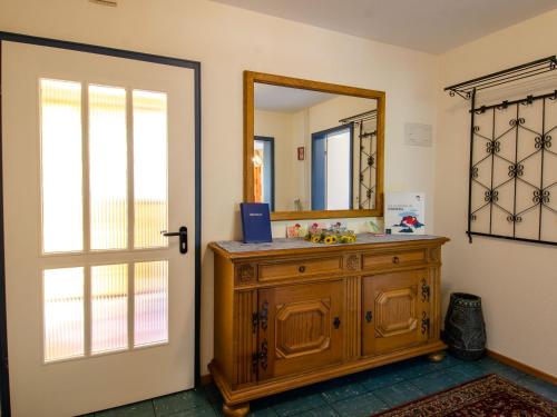 a bathroom with a wooden cabinet and a mirror at Haus Harter in Wolfach