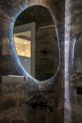 a bathroom with a mirror and a sink at Alsalos Apartment in Kardamili