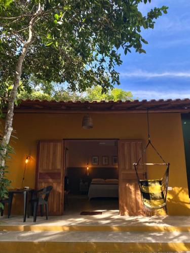 a view of a room with a bed and a patio at Chalés Borborema Cumuru in Prado