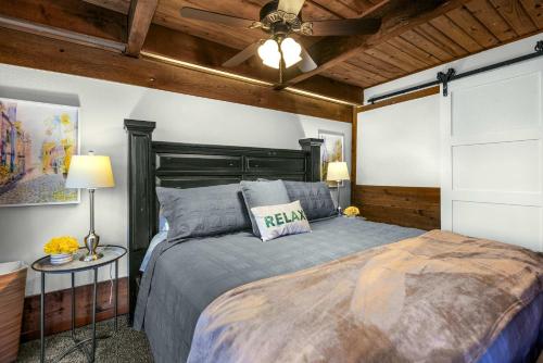 a bedroom with a bed and a ceiling fan at Cedar Nest - Experience Ozark Magic in Sunrise Beach in Sunrise Beach