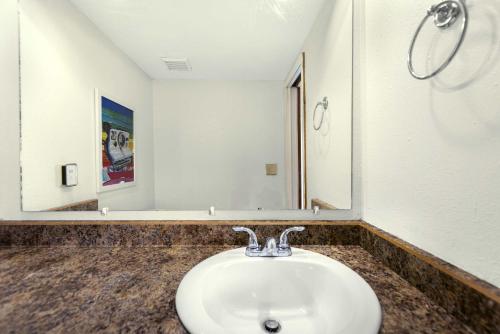 a bathroom with a sink and a mirror at Cedar Nest - Experience Ozark Magic in Sunrise Beach in Sunrise Beach