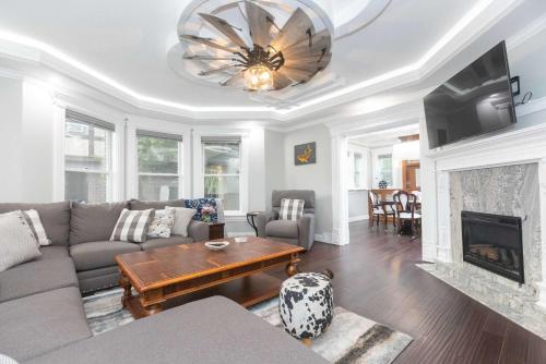 a living room with a couch and a fireplace at Its Showtime - Historic Downtown Geneva Escape in Lake Geneva