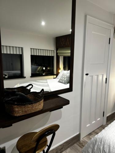 a bedroom with a mirror and a bed and a chair at Springvale Lodge in Castlerock