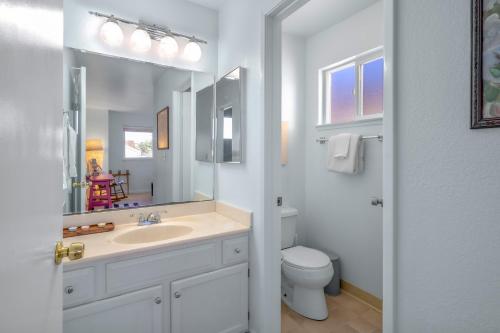 a white bathroom with a sink and a toilet at Succulents and Seashells - Coastal Paradise by Beach in Marina