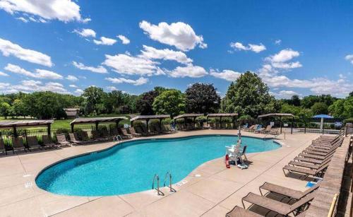 a large swimming pool with lounge chairs at Abbey Springs - Private Community & Amenities in Lake Geneva