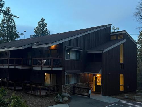 a black house with a porch and a balcony at Elmer's Hideout - Fully Renovated Yosemite Escape in Yosemite West