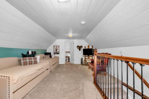 a living room with a couch and a tv at CC Cabin - Full Game Room & Wrap Around Deck in Shaver Lake