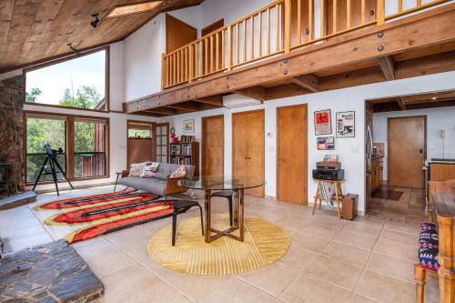 a living room with a table and a couch at Happy Days Retreat with Private Pool in Bass Lake Annex