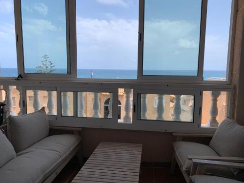a living room with two couches and a view of the ocean at Cabo Cervera Sea View in Torrevieja