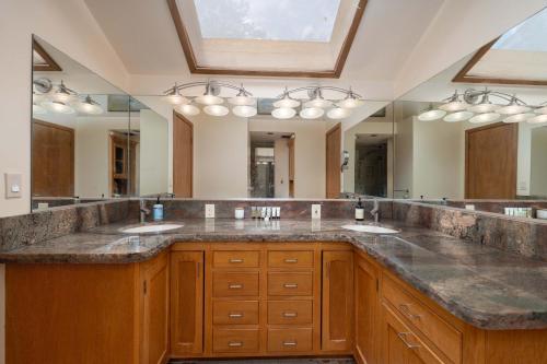 a bathroom with two sinks and a large mirror at Happy Days Retreat with Private Pool in Bass Lake Annex