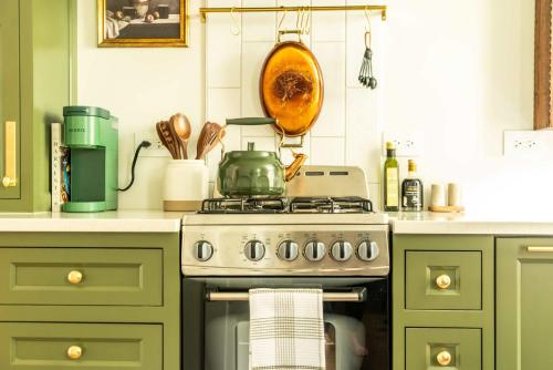 a kitchen with a stove with a pot on it at Magnolia Manor - Remodeled Home Near Downtown in Lake Geneva