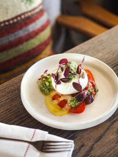 a white plate with food on a table at Artist Residence Oxfordshire in Oxford