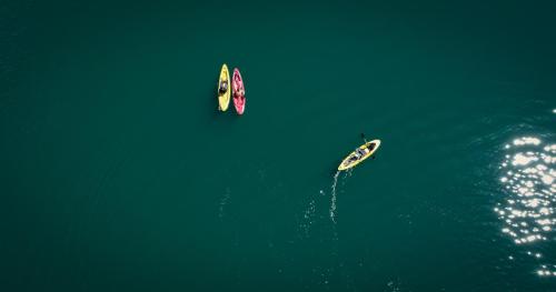 a group of three boats in the water at Arcadian 3Skies Borith Lake in Pasu